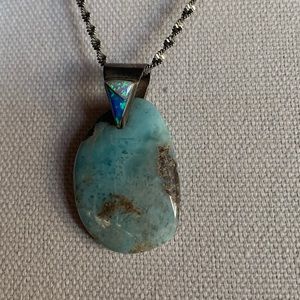 Opalesque pendant. 1 1/2”.Shades of Blues greens.